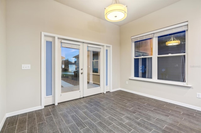 empty room with french doors and dark wood-type flooring