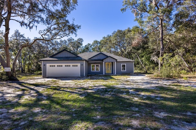 craftsman-style house featuring a garage and a front yard