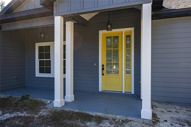 view of exterior entry with covered porch