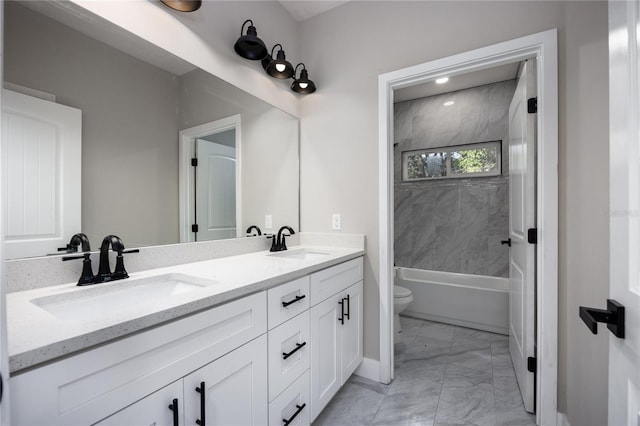 full bathroom with tiled shower / bath, vanity, and toilet