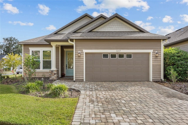 1237 NW 137th Way, Newberry, FL 32669 - craftsman-style home featuring decorative driveway, a front lawn, a garage, and a shingled roof