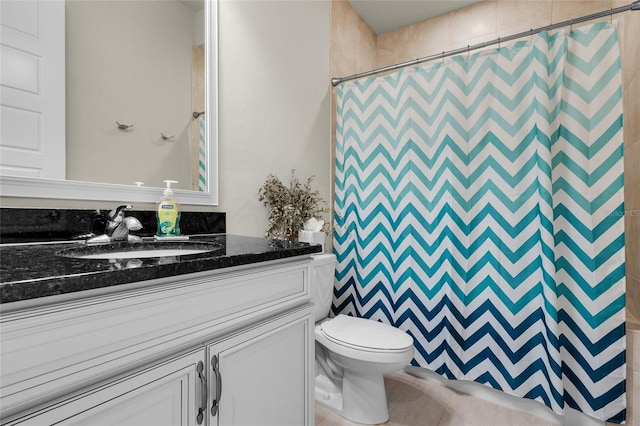 bathroom featuring walk in shower, vanity, and toilet