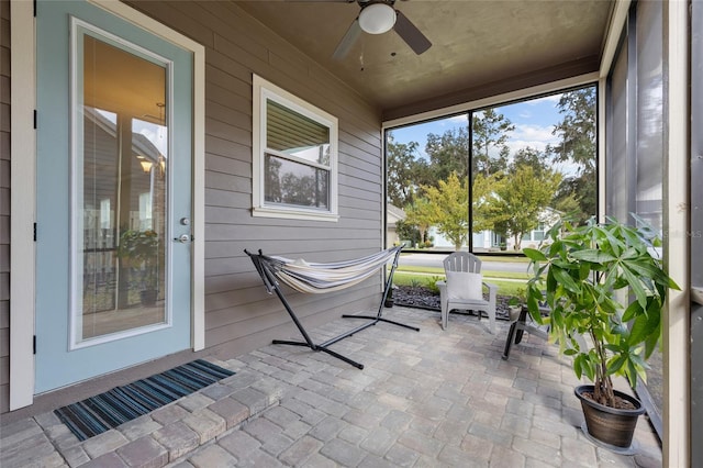 unfurnished sunroom with ceiling fan and a healthy amount of sunlight