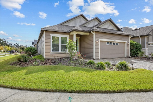 view of front of property with a garage and a front lawn