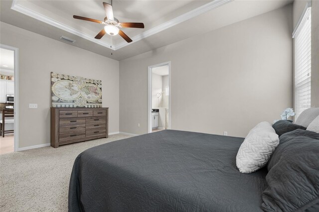 carpeted bedroom with connected bathroom, ceiling fan, and a tray ceiling