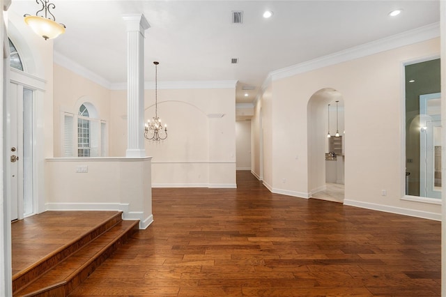 unfurnished room with dark hardwood / wood-style floors, crown molding, and decorative columns