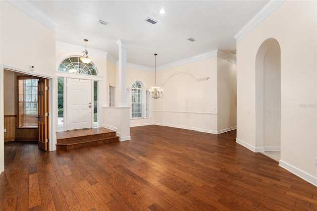 foyer entrance with ornamental molding, a chandelier, and dark hardwood / wood-style floors