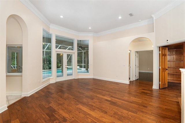 unfurnished room with ornamental molding, french doors, and dark wood-type flooring