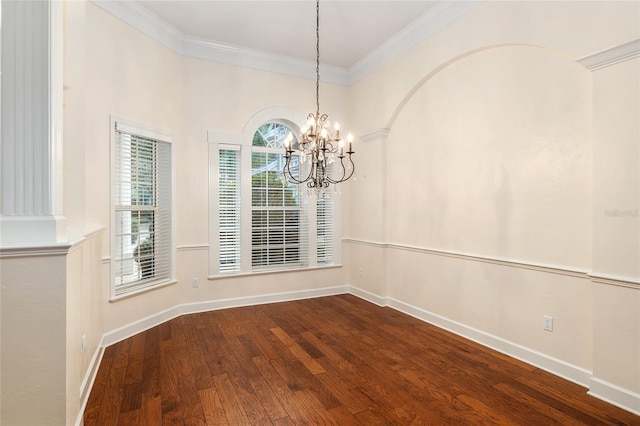 unfurnished dining area featuring an inviting chandelier, hardwood / wood-style floors, and crown molding