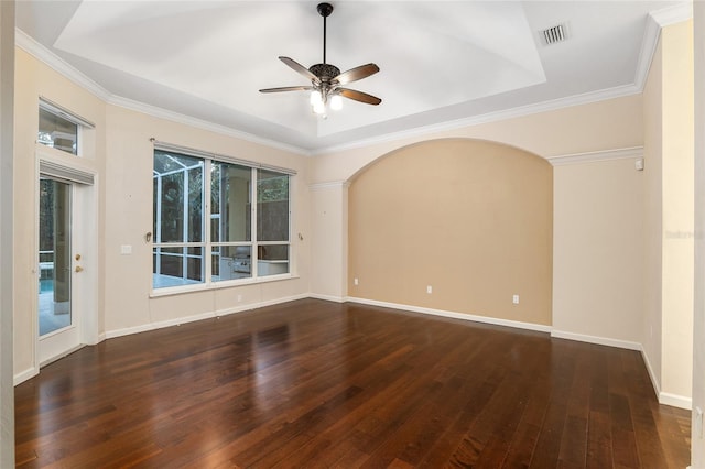 spare room with ornamental molding, dark wood-type flooring, and ceiling fan