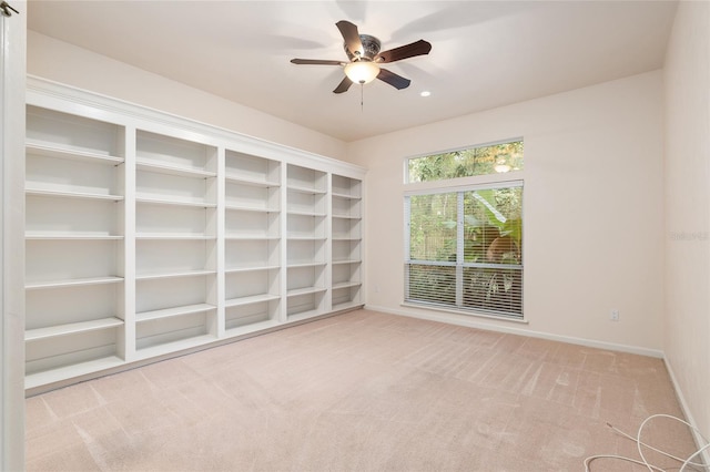 carpeted spare room with ceiling fan