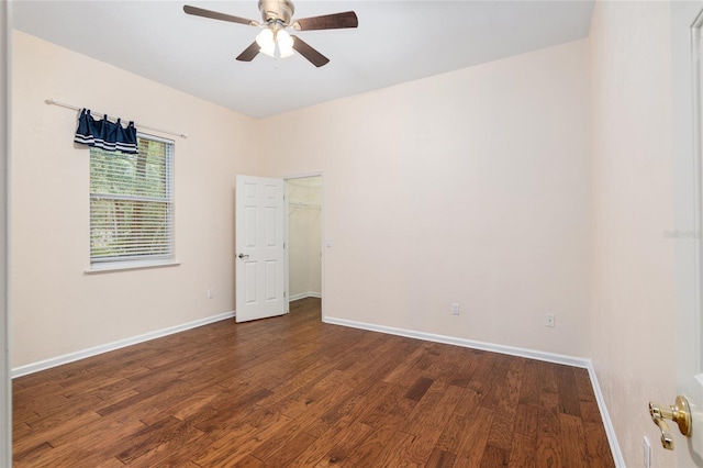 spare room featuring ceiling fan and dark hardwood / wood-style flooring