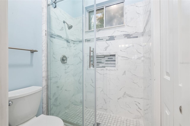 bathroom featuring walk in shower and toilet