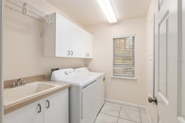 laundry area featuring cabinets, sink, washer and dryer, and light tile patterned floors