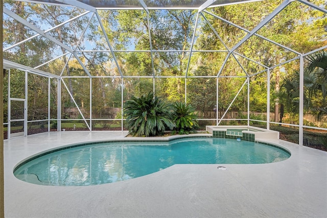 view of pool with a lanai, a patio, and an in ground hot tub