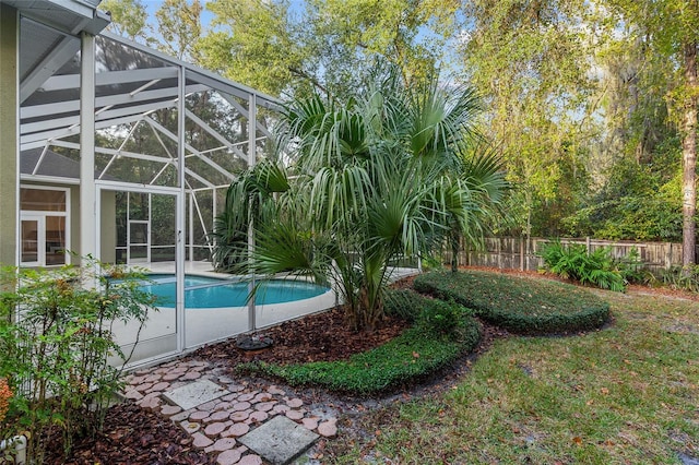 view of swimming pool with a patio and a lanai