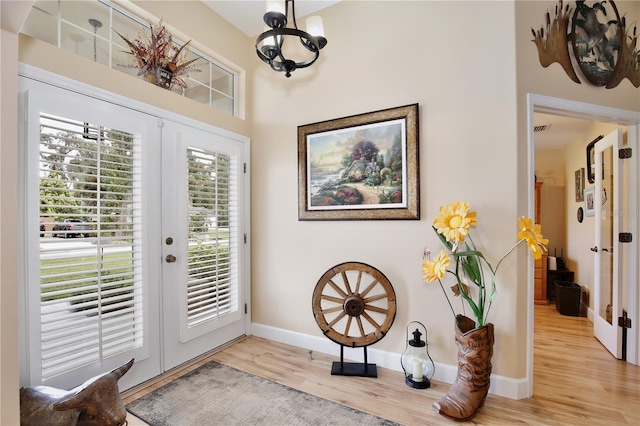 doorway with light hardwood / wood-style flooring and french doors