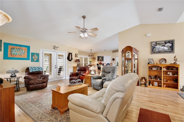 living room featuring ceiling fan, french doors, vaulted ceiling, and light hardwood / wood-style floors