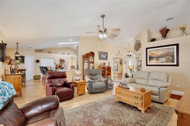 living room featuring ceiling fan, light hardwood / wood-style flooring, and lofted ceiling