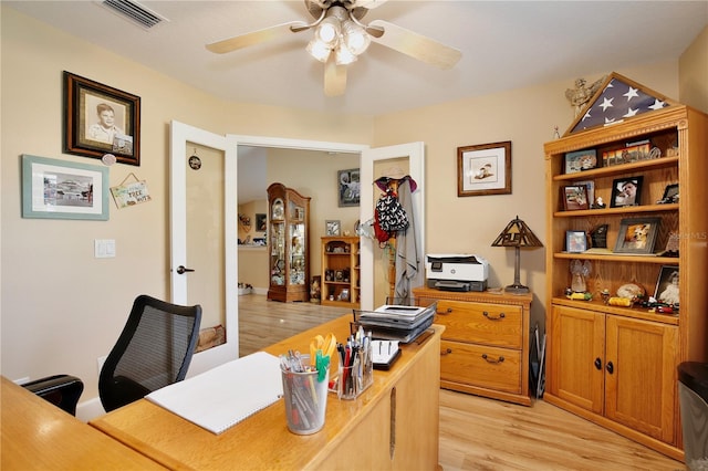 home office featuring light wood-type flooring and ceiling fan