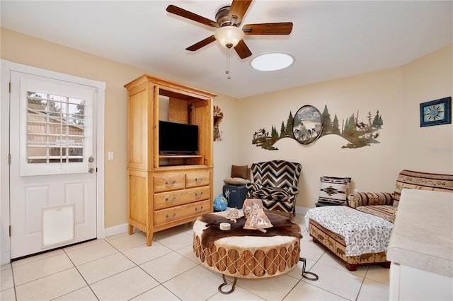 sitting room with ceiling fan and light tile patterned floors