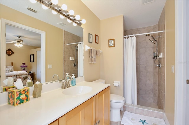 bathroom with toilet, ceiling fan, vanity, and curtained shower