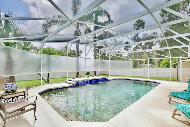 view of pool featuring a patio, glass enclosure, and pool water feature