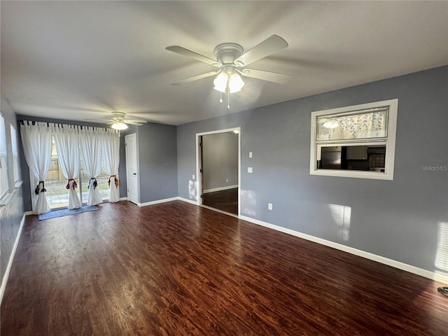 unfurnished living room with a ceiling fan, wood finished floors, and baseboards