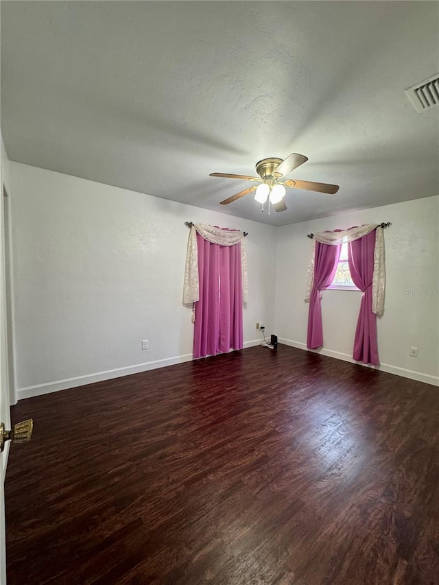 unfurnished room featuring ceiling fan, baseboards, and wood finished floors