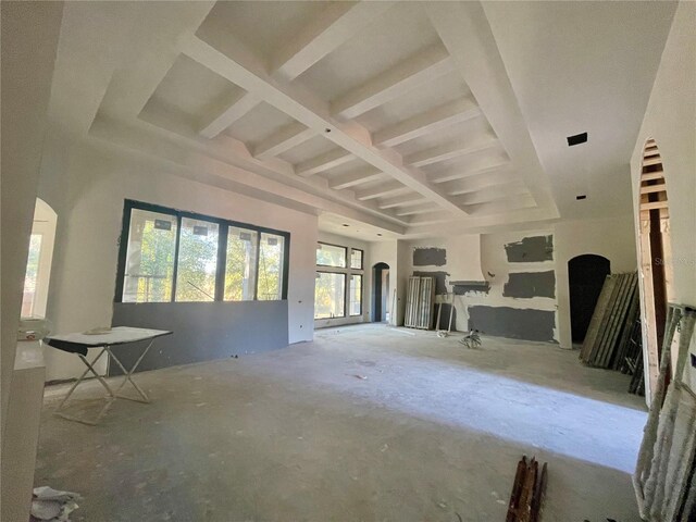 unfurnished living room featuring coffered ceiling