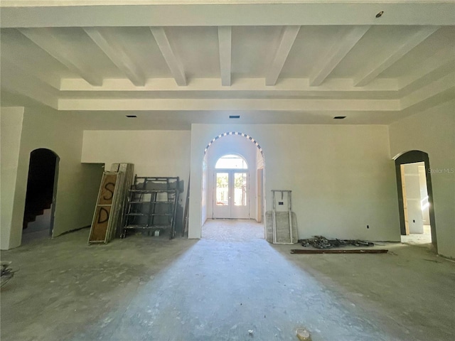 unfurnished living room featuring beam ceiling