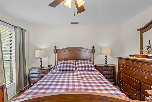 bedroom with multiple windows and ceiling fan