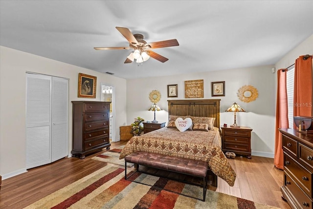 bedroom featuring a closet, wood-type flooring, and ceiling fan