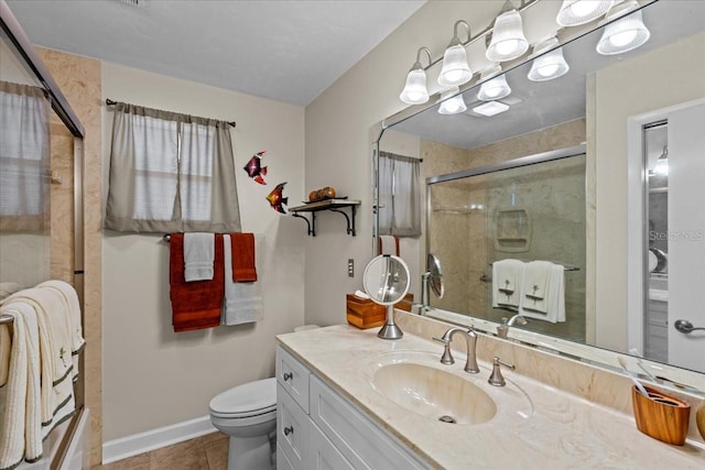 bathroom featuring walk in shower, toilet, vanity, and tile patterned floors