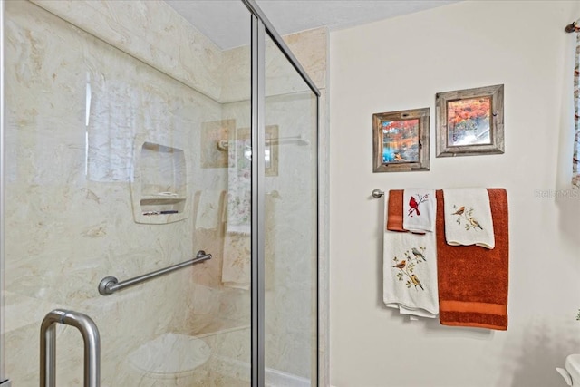 bathroom with a shower with door