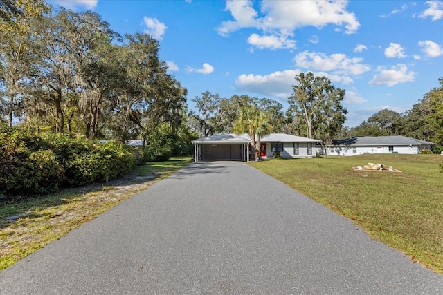 ranch-style home with a carport and a front lawn