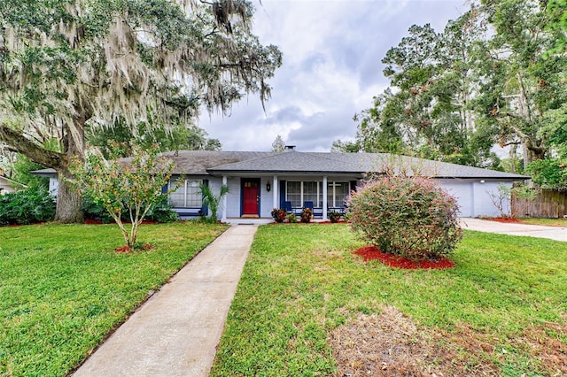 single story home with a garage and a front lawn