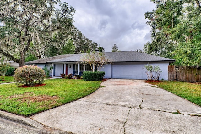 single story home featuring a garage and a front yard