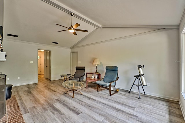 living area with light hardwood / wood-style floors, vaulted ceiling with beams, and ceiling fan