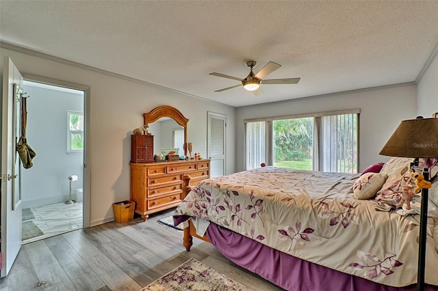 bedroom with multiple windows, a textured ceiling, ceiling fan, and light hardwood / wood-style flooring