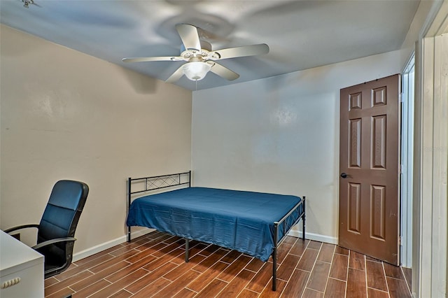 bedroom featuring dark wood-type flooring and ceiling fan