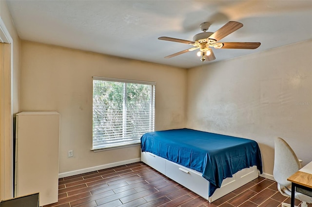 bedroom with ceiling fan and dark hardwood / wood-style flooring