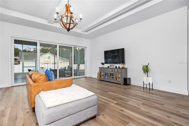 living room featuring hardwood / wood-style flooring and an inviting chandelier