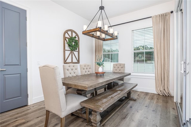 dining space with a chandelier and light hardwood / wood-style flooring