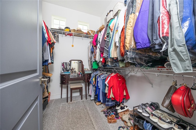 walk in closet with carpet floors