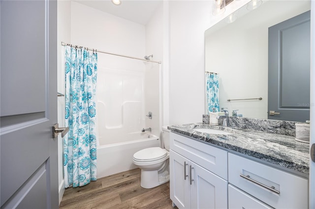 full bathroom with vanity, shower / tub combo, toilet, and hardwood / wood-style flooring