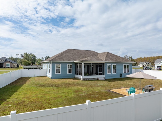 view of front of home featuring a front yard and a sunroom