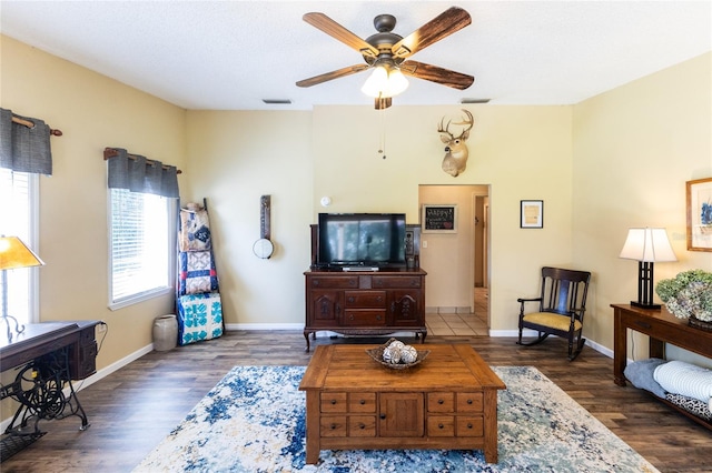 living room featuring ceiling fan and dark hardwood / wood-style flooring