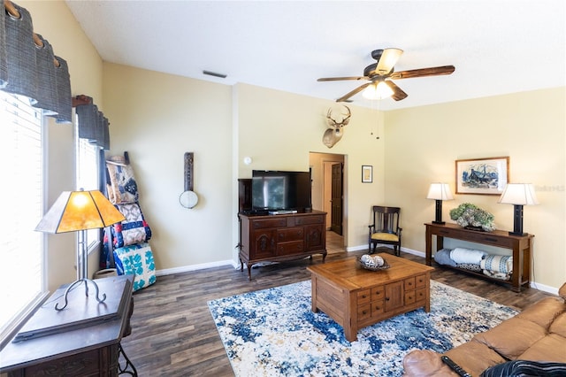 living room featuring dark hardwood / wood-style floors and ceiling fan