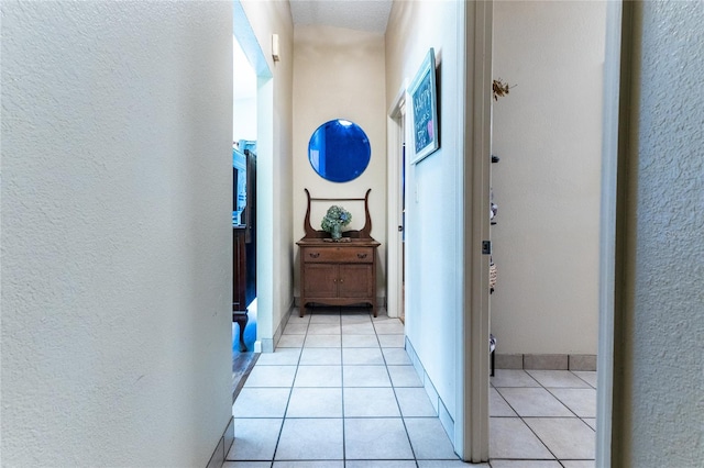 hall featuring light tile patterned floors